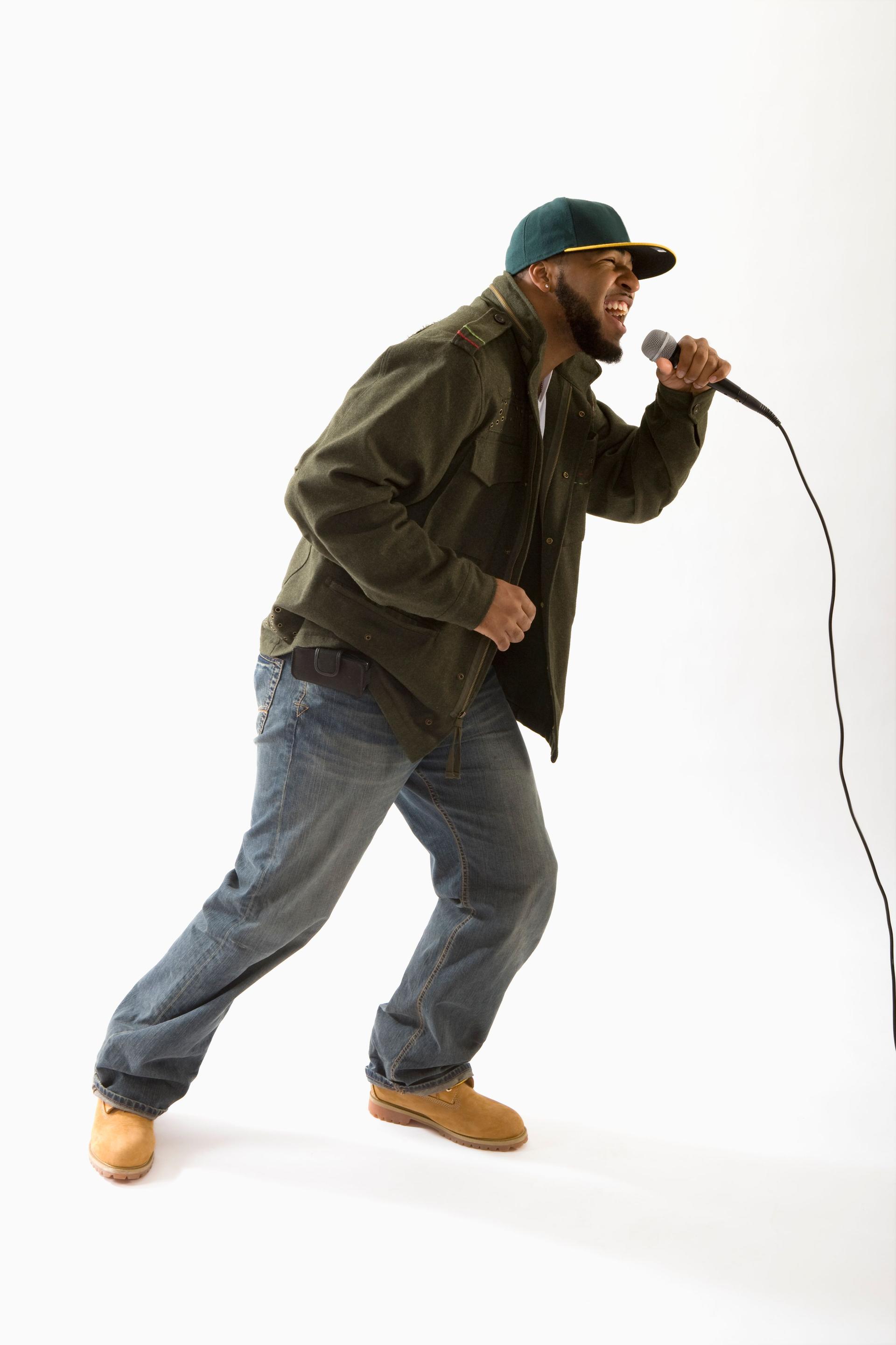 A hip hop artist singing into a microphone